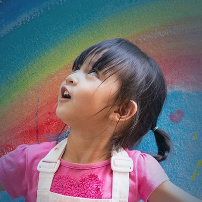Child marveled at painted rainbow