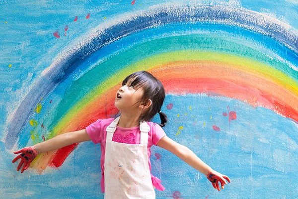 Child marveled at painted rainbow