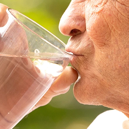 Photo of a senior sipping on a water glass