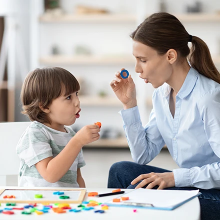 Photo of a boy with a speech therapist