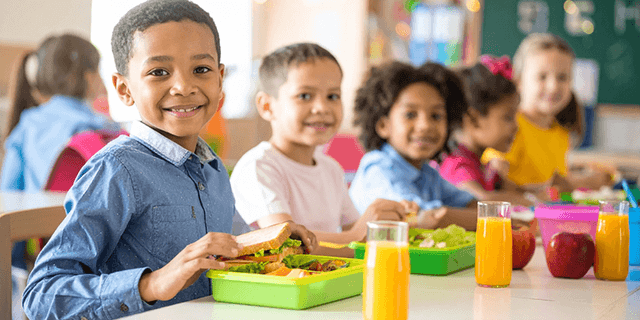 Kids smiling in cafeteria
