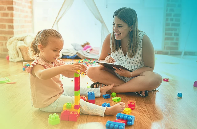 Toddler playing while being observed by therapist