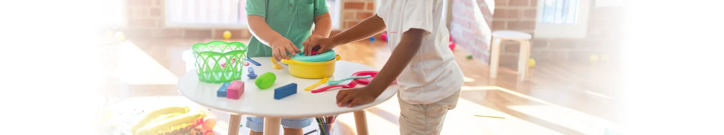Two young children interacting with therapeutic toys together