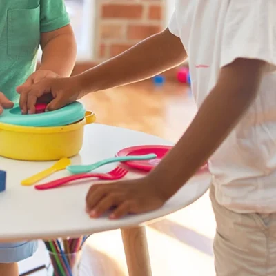 Two young children interacting with therapeutic toys together