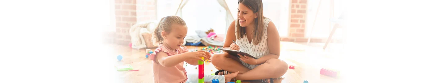 Toddler playing while being observed by therapist