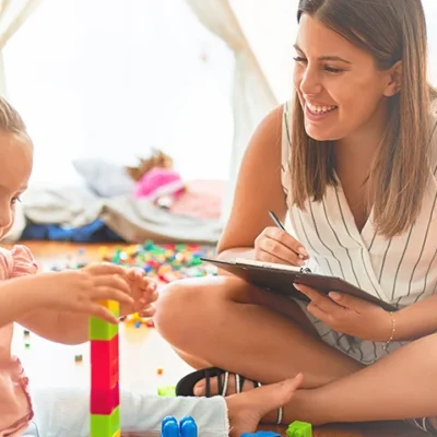 Toddler playing while being observed by therapist