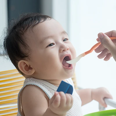 Infant being spoon fed
