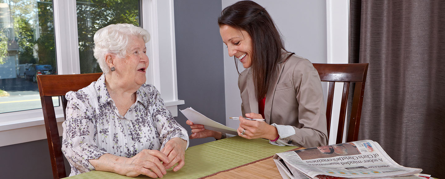 Lori smiling while interacting with a senior patient