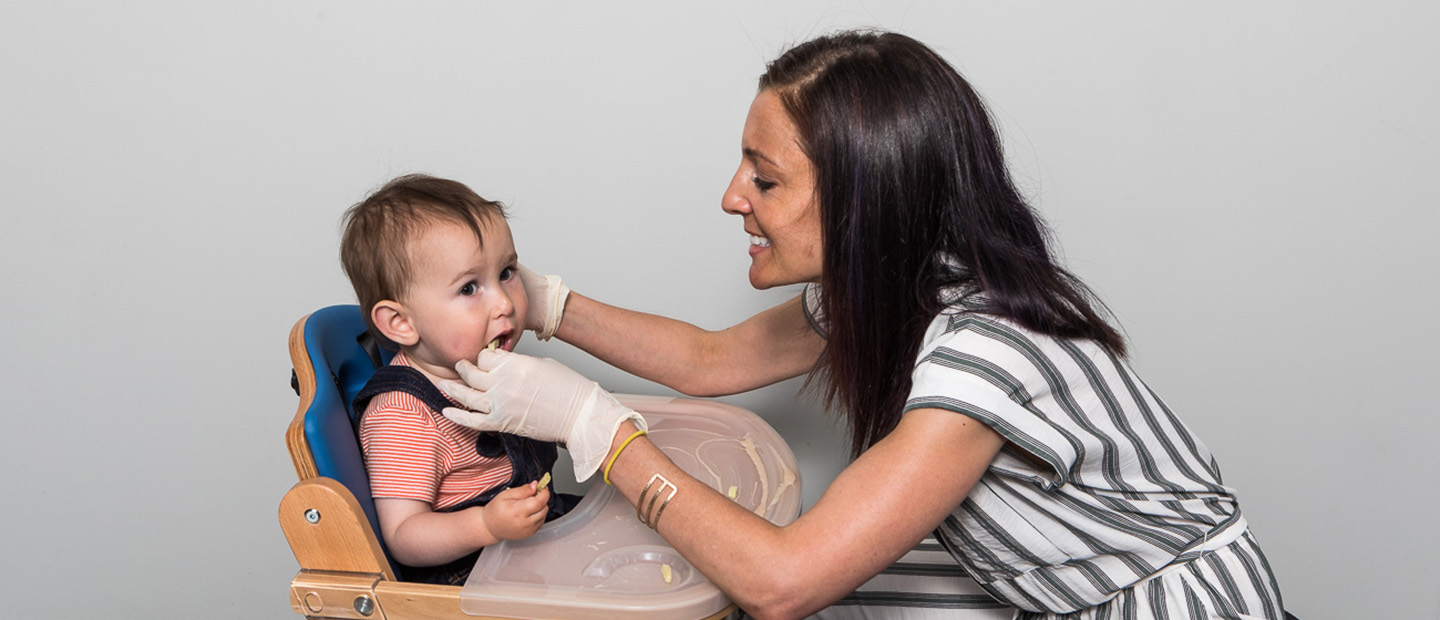 Lori feeding an infant