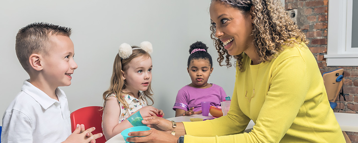 Therapist interacting with a group of infants