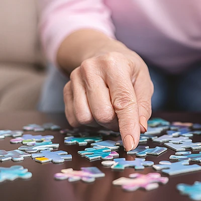 Senior solving puzzle